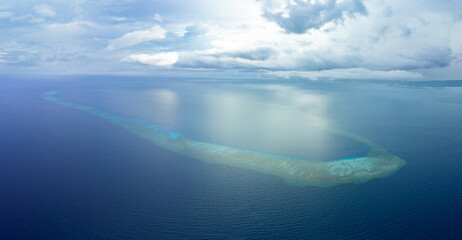 A scenic atoll is found in the Gulf of Tomini, not far from the Togian Islands of Indonesia. This beautiful area, just south of the equator, is home to an incredible array of marine biodiversity. © ead72
