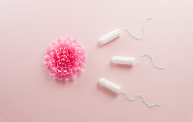 Active sperm cells swim to the flower like an egg on pink background with copy space. The concept of pregnancy, fertilization of the egg