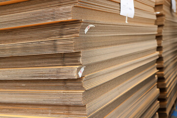 Paper factory process texture carton industry brown cardbox. container cardboard for packing, Pile of corrugated cardboard sheets and ready to use. Paper card box manufacture, raw materials industry.