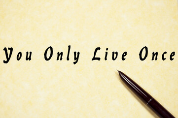 You Only Live Once write on paper