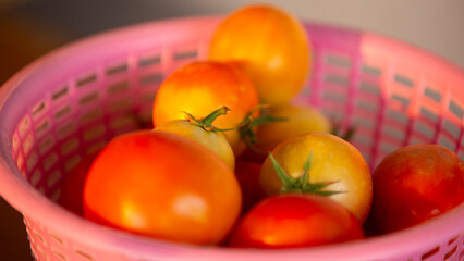 Tomatoes in a pink basket. 