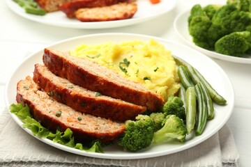 Delicious baked turkey meatloaf with mashed potato served on table, closeup