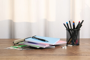 Doing homework. Notebooks and stationery on wooden desk. Space for text