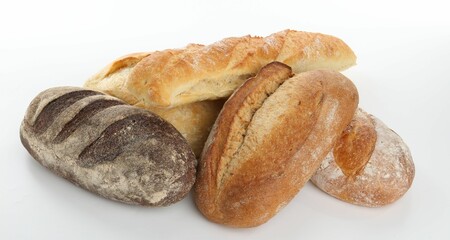 Different loaves of freshly baked bread isolated on white