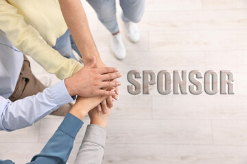 Sponsor. People holding hands together indoors, top view