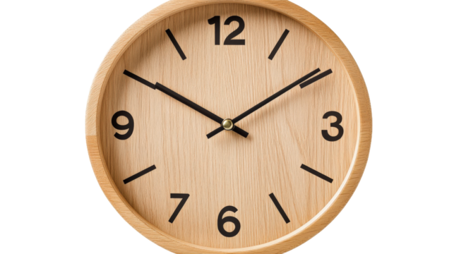 A wooden alarm clock with the hands on the numbers 3 and 9