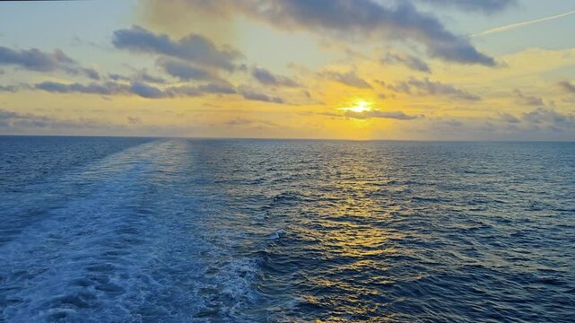 Golden sunrise-Ocean horizon-Ship Wake