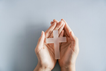 Hands holding white cross, Easter worship, thanks giving, prayer concept
