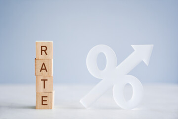 Wooden blocks with RATE and percentage sign and arrow up, financial growth, interest rate increase, hyperinflation, inflation, recession concept 
