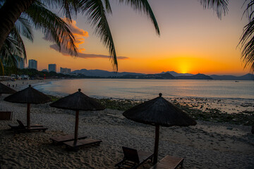 Beach daybeds and the palm trees at Dadonghai beach, Sanya, China