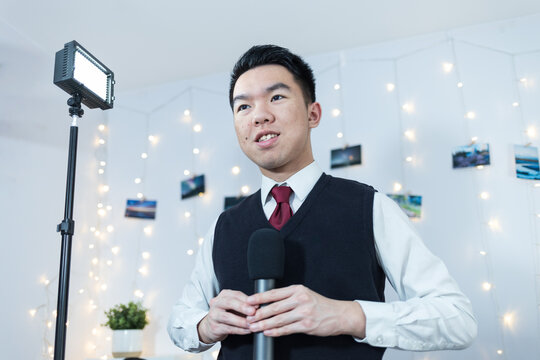 A young man takling during a recorded interview in a studio