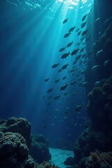 Naklejka premium school of fish swimming in the dark blue ocean, sea creatures, fish