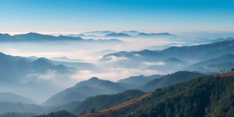 Obraz premium Aerial view of a foggy valley, layered hills and mountains in shades of blue, scenery, mountains