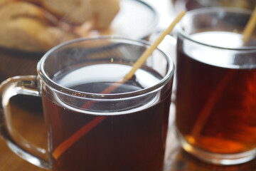 Hot tea served in clear mugs at a cozy cafe in the morning