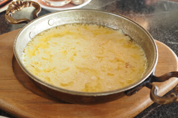 Creamy cheese dish served in a traditional metal pan