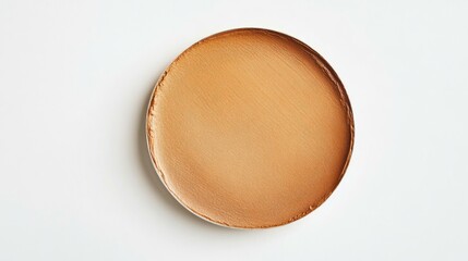 88.A close-up of a foundation swatch in a circular shape, applied with a gentle brush stroke on a clean white background, showcasing the seamless application and soft, velvety finish of the cosmetic