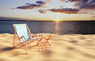 Deck chair with table on the beach against the sunset
