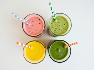 Four Colorful Smoothies in Glasses with Straws - Top View