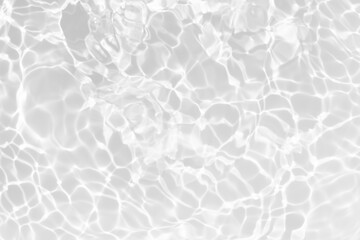 White water with ripples on the surface. Defocus blurred transparent white colored clear calm water surface texture with splashes and bubbles. Water waves with shining pattern texture background.