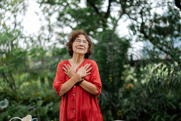 senior Woman Embracing Self-Love in Nature with Mindfulness Practices for Personal Growth and Wellness