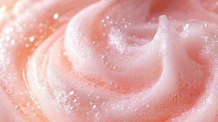 Obraz premium Close-up of swirling pink soap foam, water droplets, and soft light