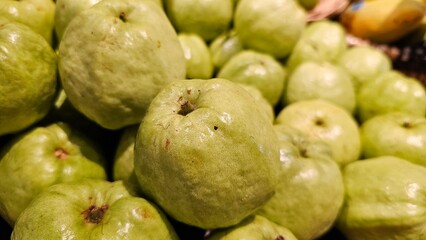 a pile of green guava fruits