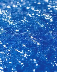 Obraz premium Captivating Blue Water Surface with Sparkling Sunlight Reflections Creates a Serene and Peaceful Visual Experience Perfect for Travel and Nature Themes