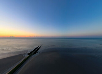 A serene and captivating view of the ocean at dusk, showcasing calming colors and a peaceful...