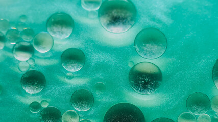 Chemical blob. Drop background. Defocused green color ink in water sparkling oil round fluid flow emulsion spilling on abstract art.