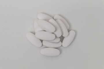 Pile of medicine pills on white background