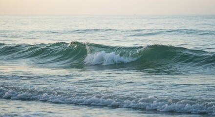 Fototapeta premium Serene Ocean Waves Crashing on Sandy Shore at Sunset Coastal Seascape