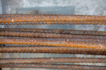 Close-up of a concrete foundation with a steel rebar cage inside, prepared for construction.