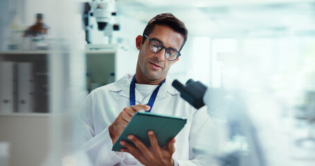 Scientist, man and tablet with research in lab for medical study by container, review or vaccine development. Person, touchscreen and chemical analysis with pharmaceutical test on app by microscope