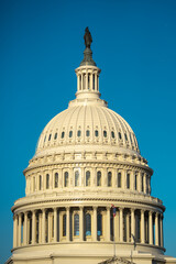Obraz premium The United States Capitol as a symbol of democracy in Washington, DC. The Capitol building on Capitol Hill. US government. American flag adorns the dome of the historic Capitol. The Senate.