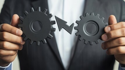 A businessman holds gears and arrows on a virtual screen, showing the development of business technology, representing the concept of investment or market trends