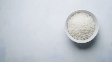 Cooked white rice fills a bowl against a light background