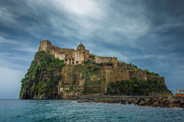 Ischia, Italy with Aragonese Castle in the Mediterranean at dusk