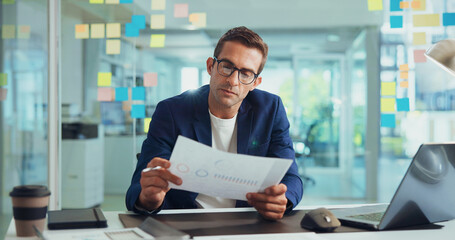 Businessman, finance or documents with statistics for analytics or company performance at office. Man, employee or financial analyst with paperwork or chart for business growth or report at workplace
