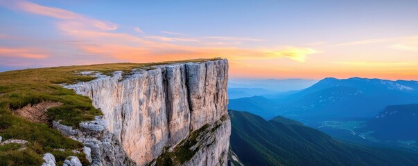 Mountain range landscapes concept. A breathtaking view of a rocky cliff during sunset in a mountainous region.