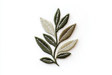 Fototapeta premium Embroidered leaf sprig on white background