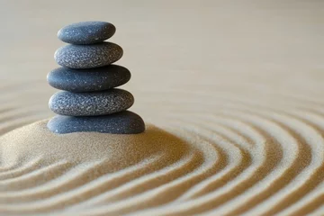 A calming and balanced arrangement of zen stones on a bed of soft sand, bringing peace and balance to the mind and body.