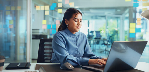 Business, woman and typing on laptop at creative agency for news story, article research and proofreading blog. Project, journalist or happy in office for web publication, feedback review or planning