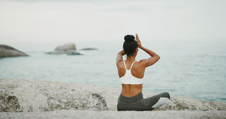Ocean, calm and meditation for woman, outdoor and spiritual practice for wellness, peace and relax. Back, chakra and self awareness with person, mindfulness and yoga with prayer hands for zen