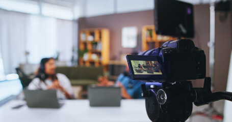 Camera, podcast and streaming with people in home living room for live broadcast or recording. Content creation, conversation or review with man and woman influencer in apartment for social media