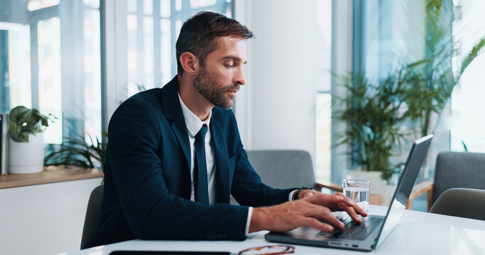 Tired, businessman and typing with laptop for communication, network or email at office desk. Man, accountant or fatigue with computer for online research, finance or digital report at workplace