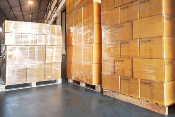 Bulk of Package Boxes Stacked on Pallets in Warehouse. Cartons, Cardboard Boxes. Storage Warehouse....