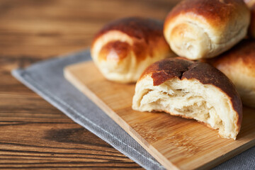 Homemade buns on a wooden background. Selective focus.