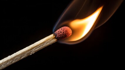 Ignition: A matchstick bursts into a vibrant flame against a dark background, showcasing the raw power and delicate dance of fire, capturing a moment of pure energy and transformation.