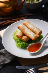 a plate of risoles with mustard greens and sauce