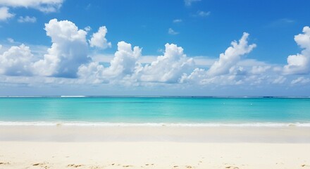 Fototapeta premium White sandy shore and fluffy white clouds in a bright blue sky complement a serene beach scene with a clear blue ocean, capturing tropical beauty
